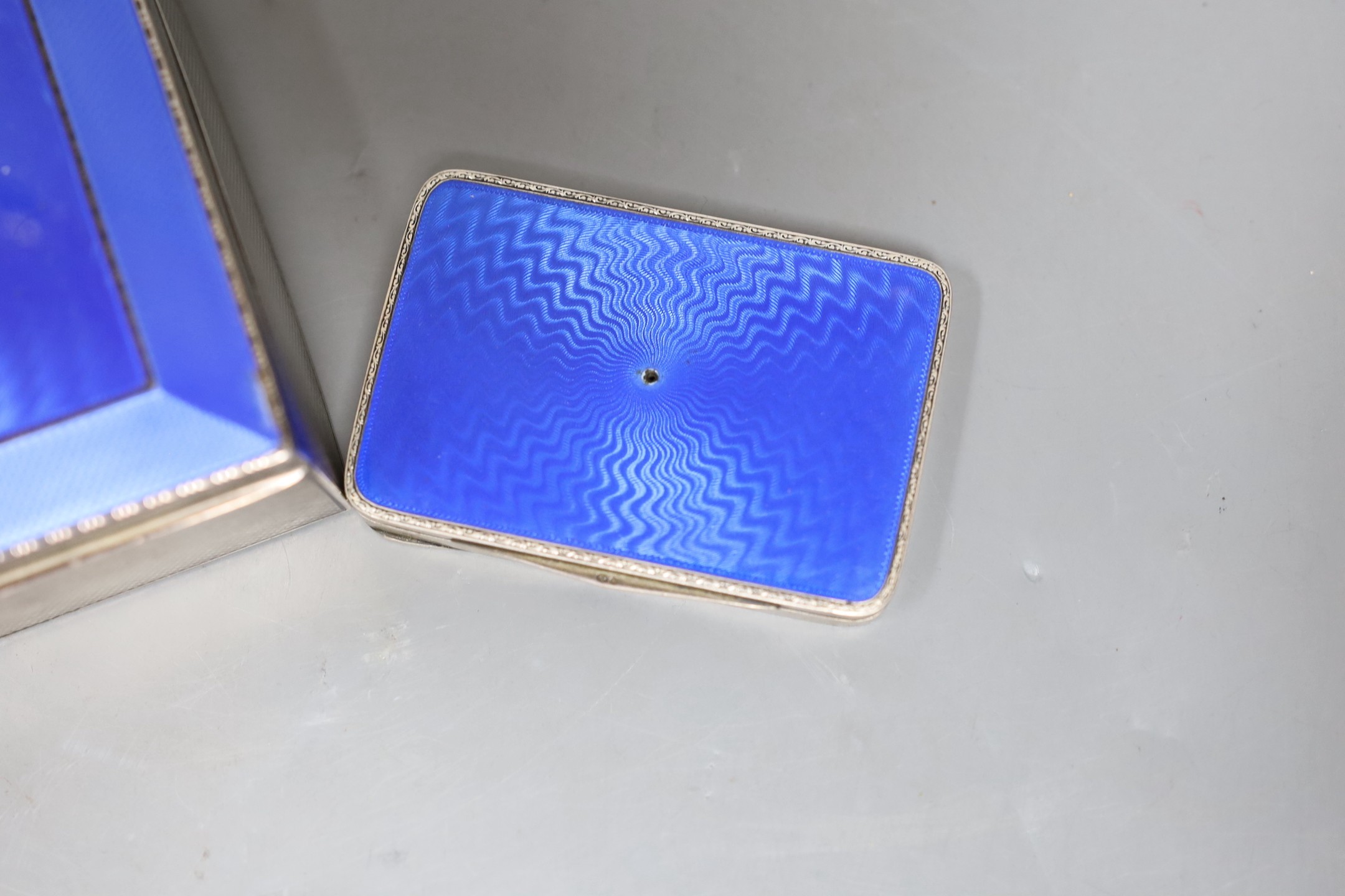 A George V silver and blue enamel cigarette box, import marks for London, 1928, 11.3cm and a Swedish white metal and enamel compact.